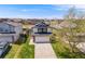 Beautifully maintained two-story home with a classic design, featuring a front-facing garage and lush green lawn in a suburban setting at 8827 Cloverleaf Cir, Parker, CO 80134