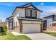 Well-maintained two-story home with a two-car garage, showcasing the architectural details and curb appeal at 8827 Cloverleaf Cir, Parker, CO 80134