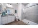 Bathroom features a walk-in shower, granite vanity and modern fixtures at 16130 E 111Th Dr, Commerce City, CO 80022