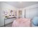 Spacious bedroom with pink bedding and a view of the hallway at 16130 E 111Th Dr, Commerce City, CO 80022