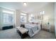 Bright bedroom with large windows, plush bedding and window seating at 16130 E 111Th Dr, Commerce City, CO 80022