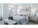 Bright bedroom with large windows, plush bedding, and window seating at 16130 E 111Th Dr, Commerce City, CO 80022