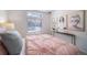 Bedroom with pink bedding, window, and stylish wall art at 16130 E 111Th Dr, Commerce City, CO 80022
