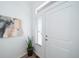 Bright entryway with wood-look floors, featuring a window and a statement art piece at 16130 E 111Th Dr, Commerce City, CO 80022