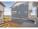 Two-story home with gray siding, deck, and backyard views at 16130 E 111Th Dr, Commerce City, CO 80022