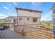 Tan siding two-story home with deck and backyard views at 16130 E 111Th Dr, Commerce City, CO 80022