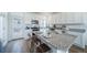 Modern kitchen with white cabinets, granite countertops and an island with seating at 16130 E 111Th Dr, Commerce City, CO 80022