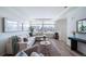 Living room with large windows, L-shaped sofa, and a view to the kitchen at 16130 E 111Th Dr, Commerce City, CO 80022