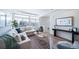 Spacious living room with large windows, L-shaped sofa and stylish decor at 16130 E 111Th Dr, Commerce City, CO 80022