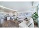 Spacious living room with large windows, L-shaped sofa, and stylish coffee table at 16130 E 111Th Dr, Commerce City, CO 80022