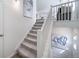 Modern staircase with white railings and carpeted steps leading to the upper level at 16130 E 111Th Dr, Commerce City, CO 80022