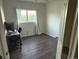 Minimalist bedroom with sleek flooring, bright window, and an adjacent desk space for work or study at 7883 S Kalispell Cir, Englewood, CO 80112