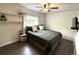 Comfortable bedroom features a ceiling fan, stylish shelves, and a relaxing atmosphere for restful nights at 7883 S Kalispell Cir, Englewood, CO 80112