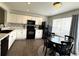 Modern kitchen with white cabinets and black appliances at 7883 S Kalispell Cir, Englewood, CO 80112