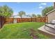 Well-maintained backyard with grass, a wooden fence, and a seating area at 21125 E 43Rd Ave, Denver, CO 80249