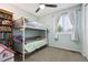 bedroom with a bunkbed, window, and bookcase at 21125 E 43Rd Ave, Denver, CO 80249