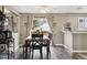 Well-lit dining area with wood flooring, a sliding door to the yard, and an adjacent breakfast bar at 21125 E 43Rd Ave, Denver, CO 80249