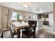 Dining room features wood floors, slider to the backyard, and view to the kitchen with a breakfast bar at 21125 E 43Rd Ave, Denver, CO 80249