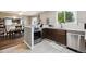 Open kitchen and dining area with modern appliances, breakfast bar, and tile flooring at 21125 E 43Rd Ave, Denver, CO 80249