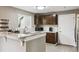 Bright kitchen featuring granite countertops, modern appliances, and a breakfast bar with seating at 21125 E 43Rd Ave, Denver, CO 80249