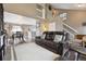 Inviting living room featuring comfortable leather seating, neutral walls, and an open floor plan leading to the dining area at 21125 E 43Rd Ave, Denver, CO 80249