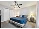 Comfortable bedroom with a ceiling fan, plush carpeting, and a spacious closet at 21125 E 43Rd Ave, Denver, CO 80249
