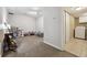 Large playroom area with neutral carpet and easy access to kitchen at 21125 E 43Rd Ave, Denver, CO 80249
