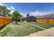 Spacious backyard featuring a grassy lawn and a detached single-car garage with alley access at 3685 Jasmine St, Denver, CO 80207