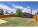 Exterior view of the spacious backyard with a detached single-car garage and tall wooden fence at 3685 Jasmine St, Denver, CO 80207