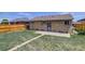Backyard view with a brick house, patio, and fenced yard at 3685 Jasmine St, Denver, CO 80207