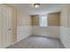 Finished basement with carpet, window, and access door at 3685 Jasmine St, Denver, CO 80207