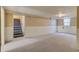 Finished basement with stairs, window, and carpet at 3685 Jasmine St, Denver, CO 80207