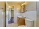 Bathroom with light wood vanity and sink, ceramic tile halfway up the wall at 3685 Jasmine St, Denver, CO 80207