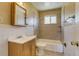 Bathroom with a tub and shower combination and light wood vanity with sink at 3685 Jasmine St, Denver, CO 80207