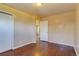 Bedroom featuring hardwood floors, neutral paint, and closet at 3685 Jasmine St, Denver, CO 80207