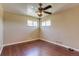 A bedroom features two windows, hard wood floors, and a ceiling fan at 3685 Jasmine St, Denver, CO 80207
