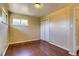 Bedroom featuring hardwood floors, closet, and neutral paint at 3685 Jasmine St, Denver, CO 80207