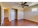 This bedroom has hardwood floors, a closet, a window, and a ceiling fan at 3685 Jasmine St, Denver, CO 80207