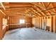 View of the one-car garage featuring a workbench, exposed rafters and concrete floor at 3685 Jasmine St, Denver, CO 80207