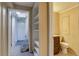 Hallway view with built in shelves and steps to unfinished basement at 3685 Jasmine St, Denver, CO 80207