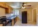 This kitchen features black appliances, a window, tile floors, and wood cabinets at 3685 Jasmine St, Denver, CO 80207