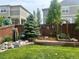 Backyard features a privacy fence and garden area with mature landscaping at 7018 E 123Rd Pl, Thornton, CO 80602