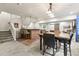 Basement bar and dining area with a staircase, chairs and unique light fixtures at 7018 E 123Rd Pl, Thornton, CO 80602