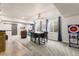 Basement with a sliding barn door, dining area, and a mounted television at 7018 E 123Rd Pl, Thornton, CO 80602