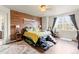 Stylish bedroom with unique wood accent wall, offering a cozy and contemporary feel at 7018 E 123Rd Pl, Thornton, CO 80602