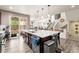 Open concept kitchen island with barstool seating and stainless steel appliances at 7018 E 123Rd Pl, Thornton, CO 80602