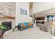 Inviting living room with a stone fireplace and a comfortable seating area at 7018 E 123Rd Pl, Thornton, CO 80602