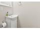 A clean and simple powder room featuring a white vanity and neutral finishes at 7018 E 123Rd Pl, Thornton, CO 80602