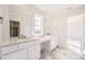 Bathroom featuring marble floors, a double sink vanity, and a large mirror at 39836 Floyd St, Elizabeth, CO 80107