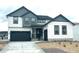Modern two-story home featuring white siding, black trim, and a two-car garage at 39836 Floyd St, Elizabeth, CO 80107